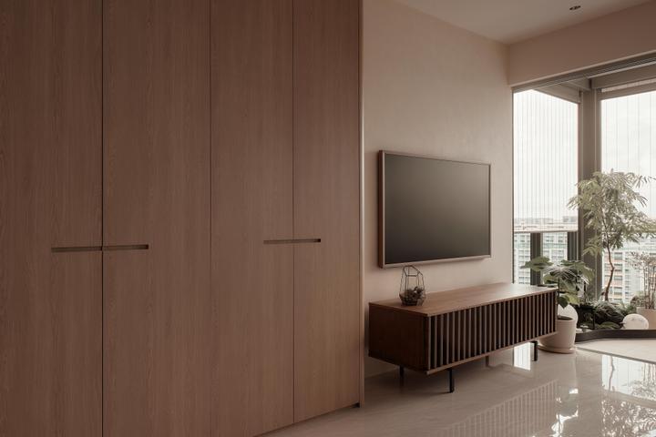 HOFT's Stars of Kovan interior with timber cabinetry and a bright balcony